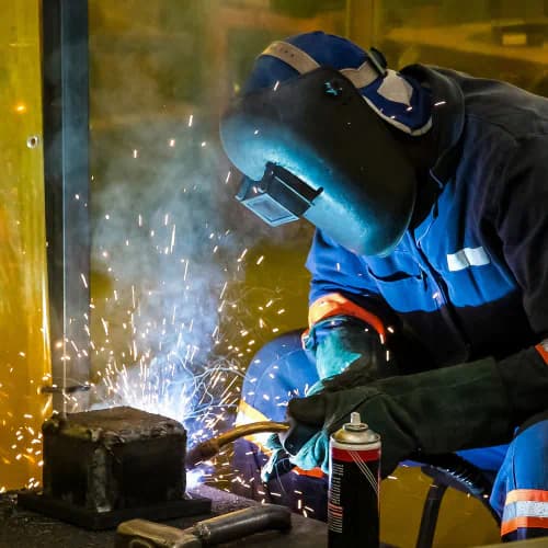 Worker using a welding torch